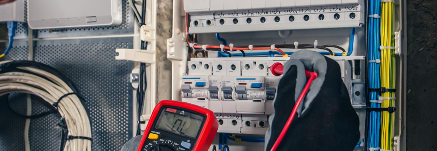 Technician working on electrical panel